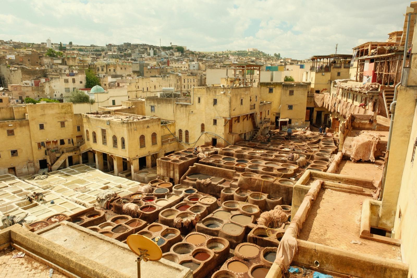 View of the historic tanneries in Fes, Morocco, showcasing traditional leather tanning vats and architecture