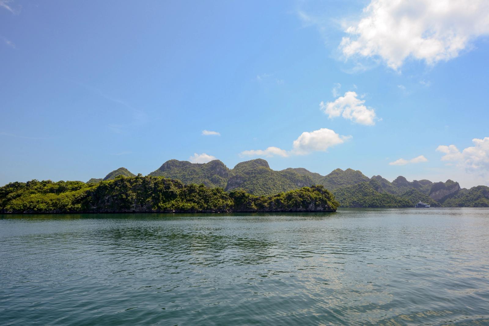 Serene landscape of Halong Bay with lush islands and clear skies