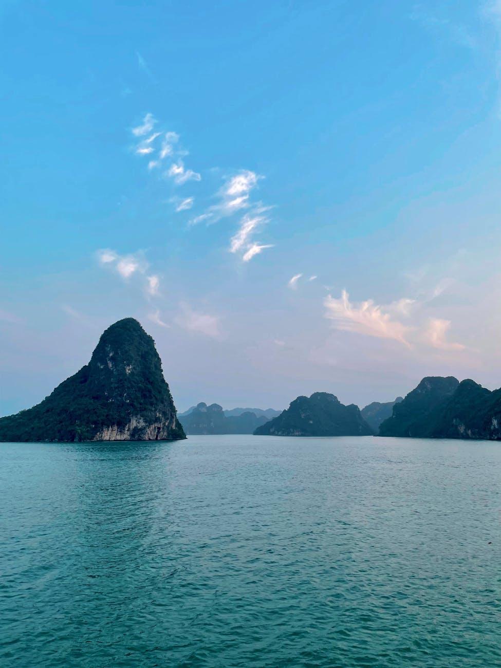 Tranquil sunset view of Lan Ha Bay's limestone karsts and calm waters in Vietnam