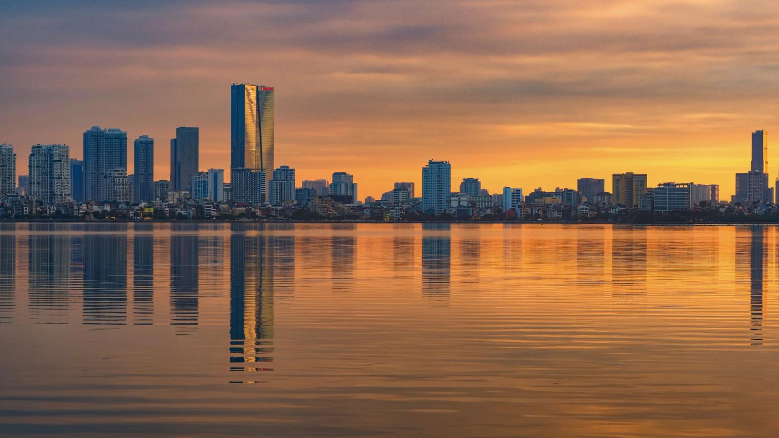 Captivating Hanoi skyline reflecting on the water during a stunning sunset in Vietnam