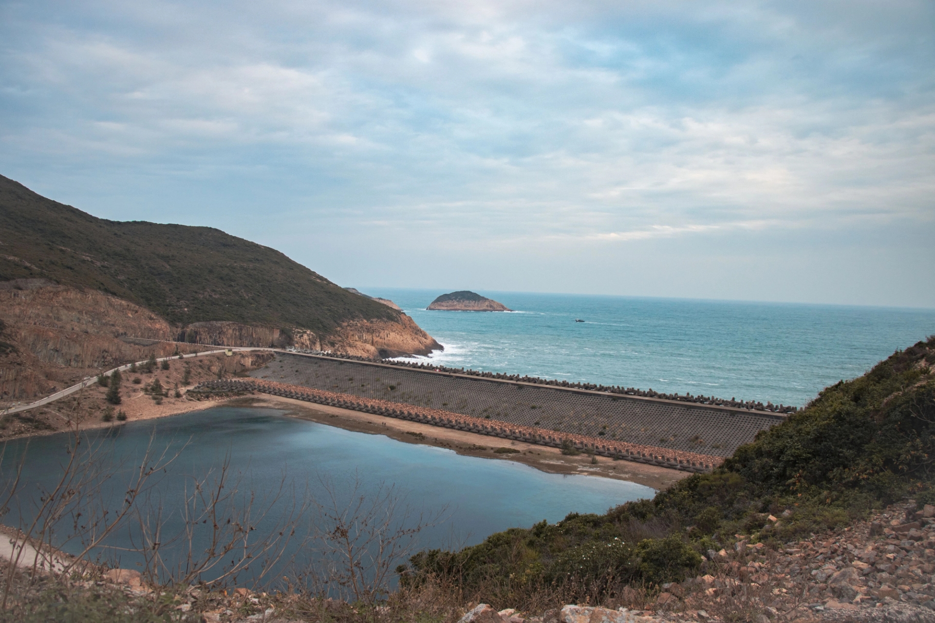 Scenic view of High Island Reservoir in Hong Kong with mountainous backdrop and sea horizon