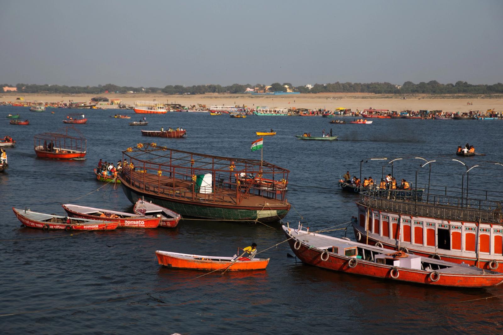 Colorful boats on the Ganges River near Varanasi ghats, capturing vibrant life and culture