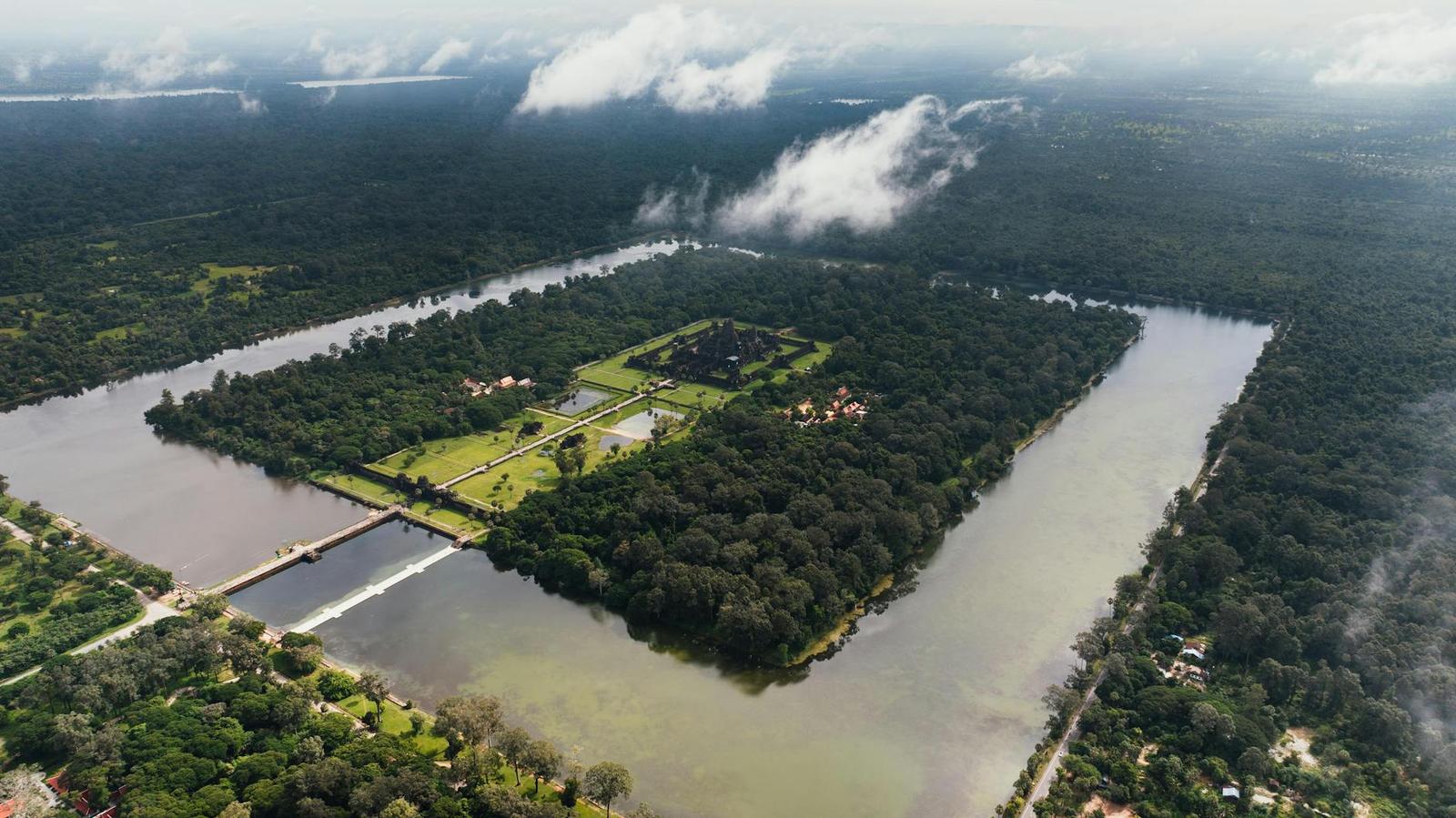 Aerial view of Angkor Wat's moated temple complex ringed by forest