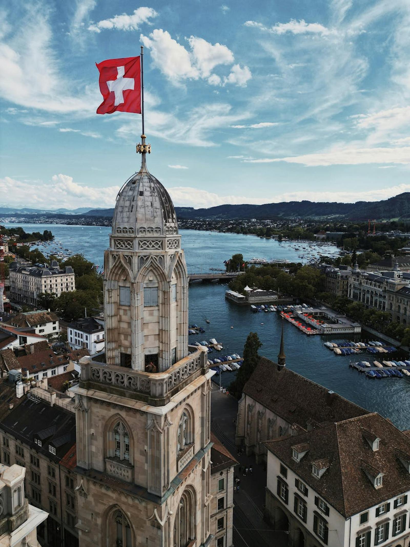 Stunning aerial view of Zurich's architecture with Swiss flag atop a church tower