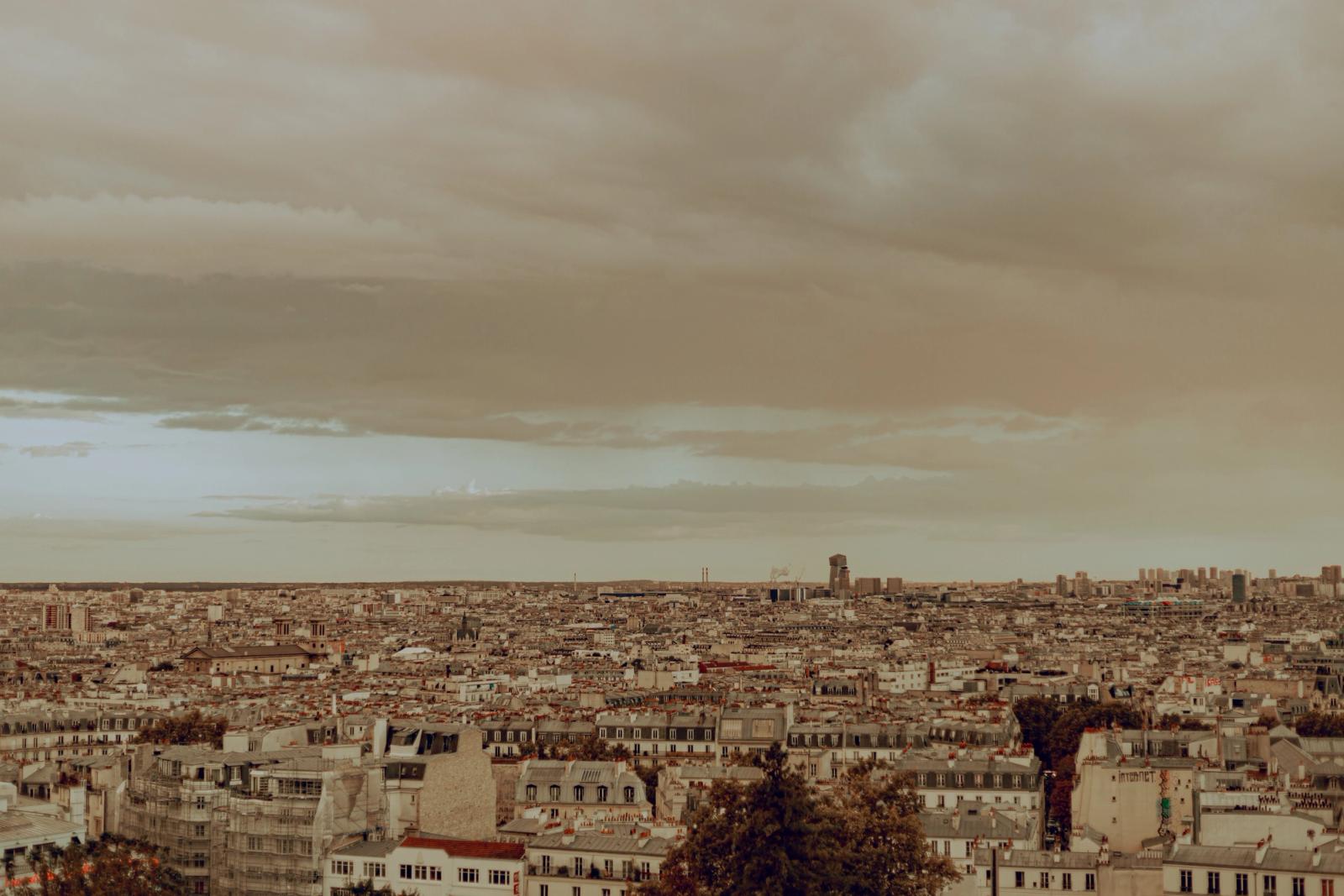 Panoramic view of Paris under an overcast sky, capturing the urban landscape in autumn