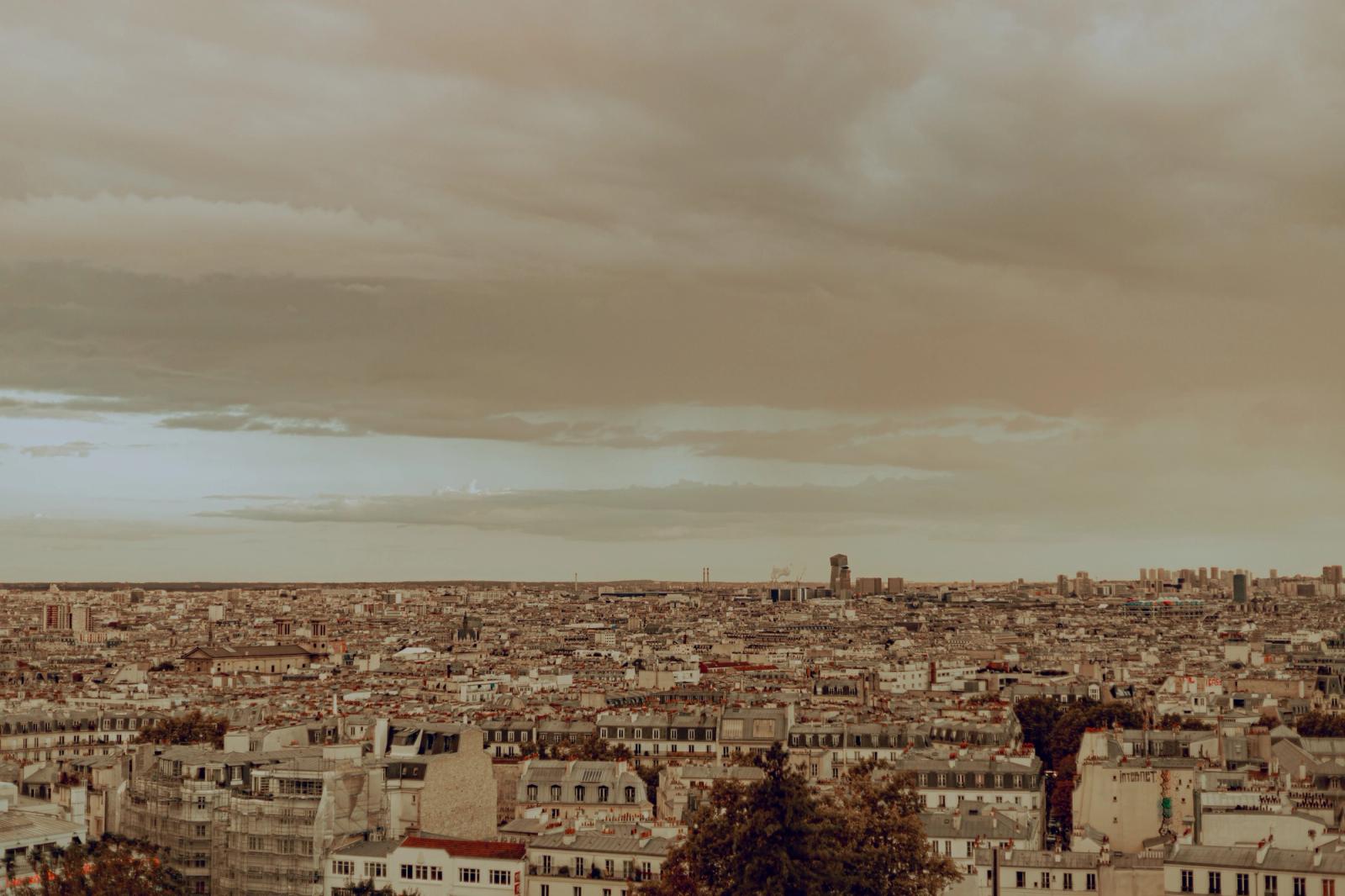Panoramic view of Paris under an overcast sky, capturing the urban landscape in autumn