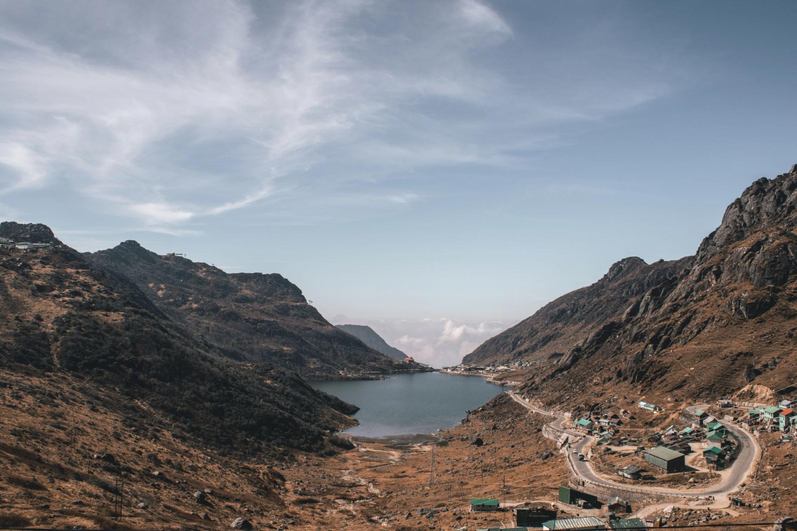 Discover the breathtaking beauty of a serene mountain lake surrounded by hills in East Sikkim, India