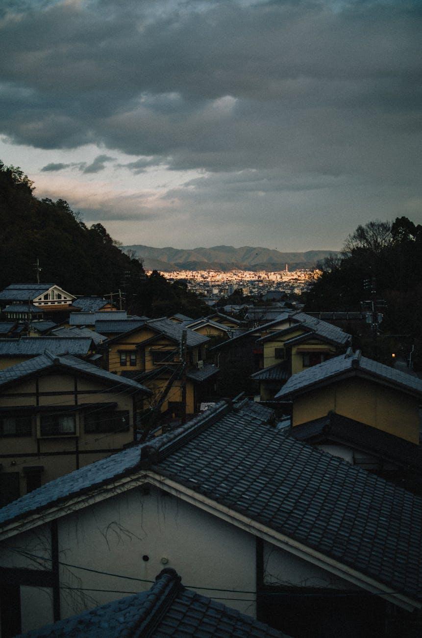 Tiled rooftops overlooking a hillside town lit up at dusk