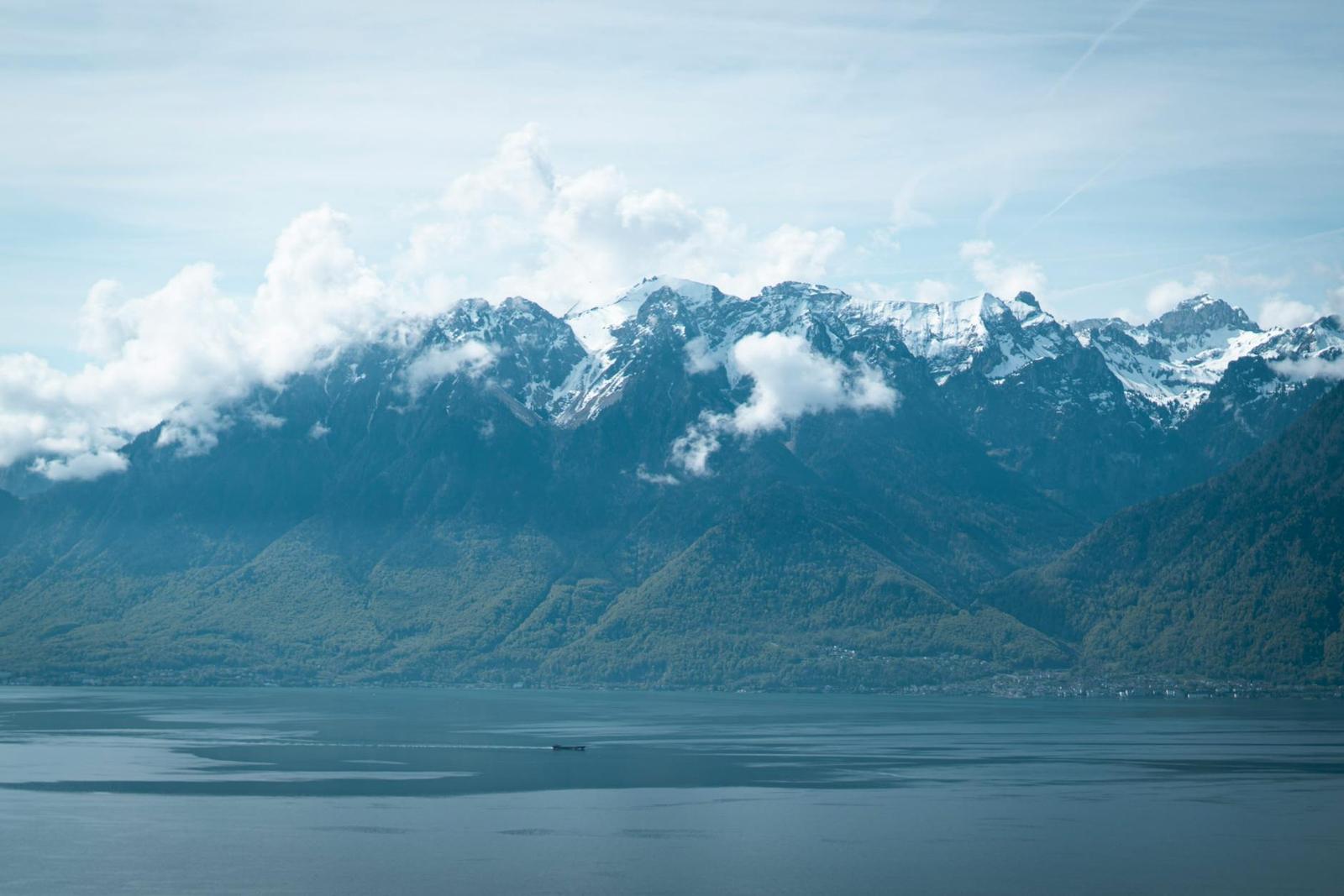 Cloud-capped mountain range rising above a wide lake