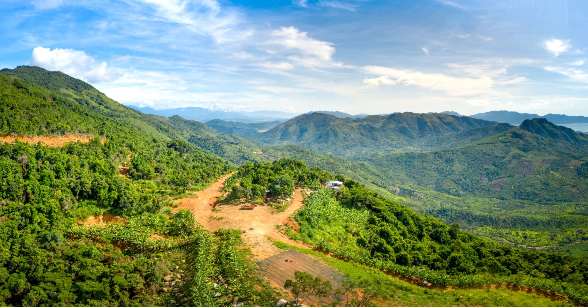 Breathtaking aerial view of verdant mountains and valleys under a clear blue sky