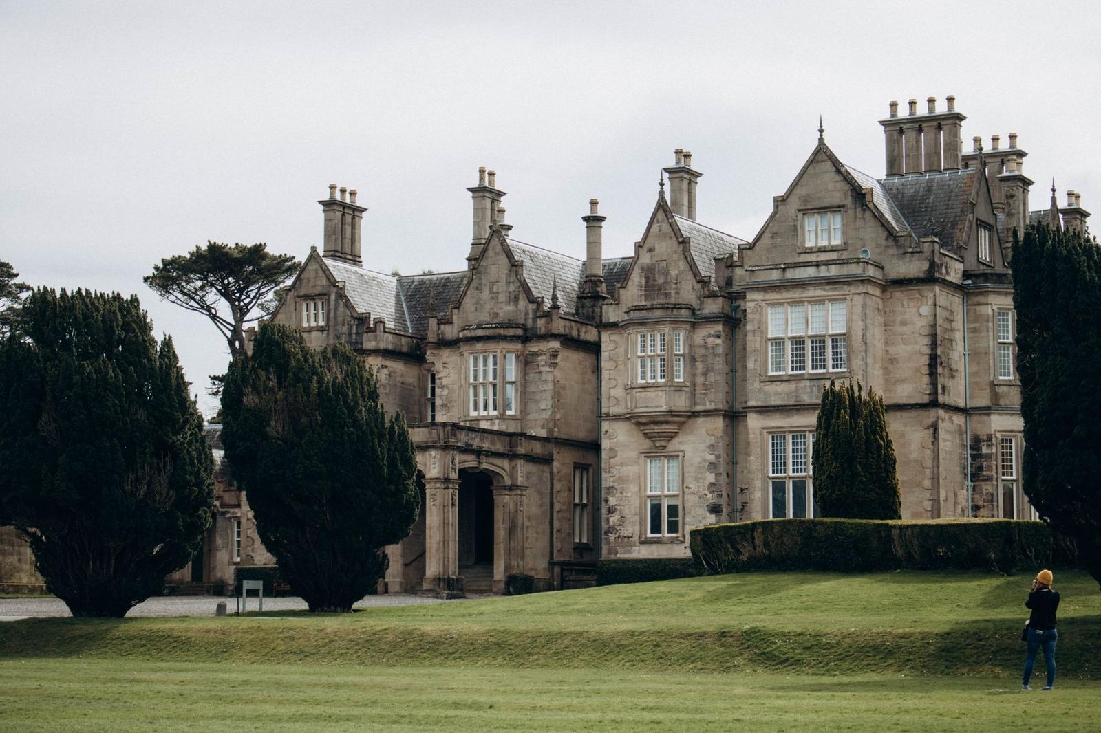 Historic Muckross House in Killarney, Ireland, surrounded by lush greenery