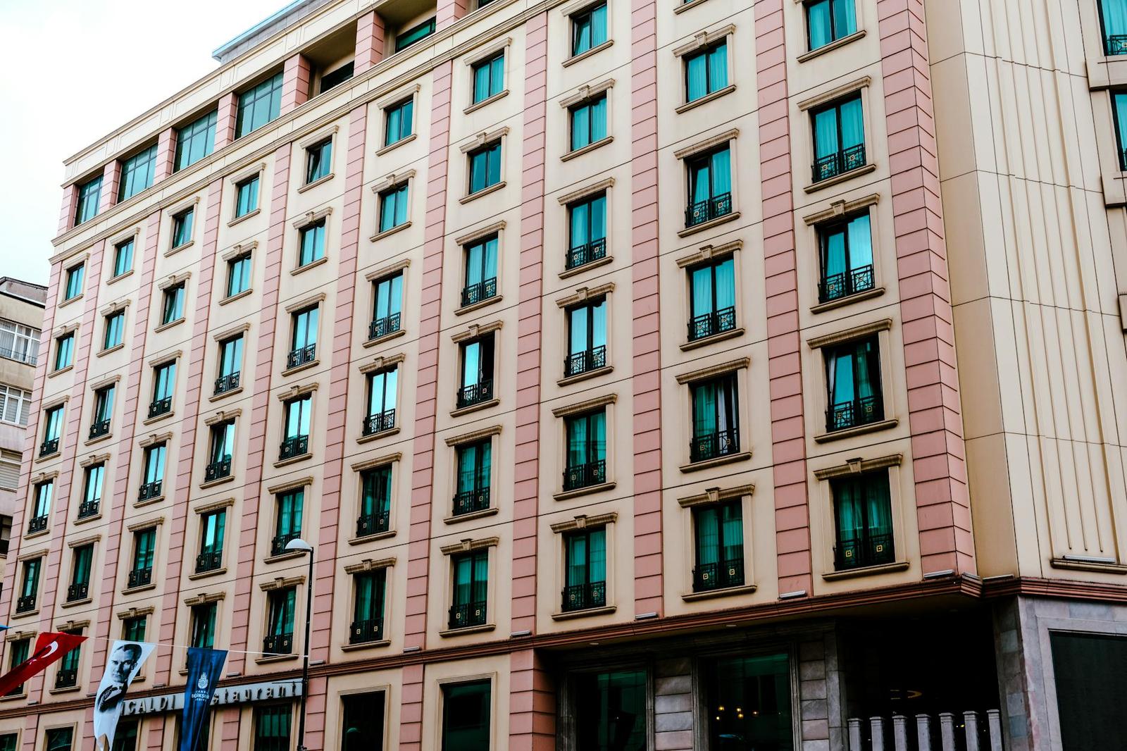 Multi-storey hotel facade with rows of arched balcony windows