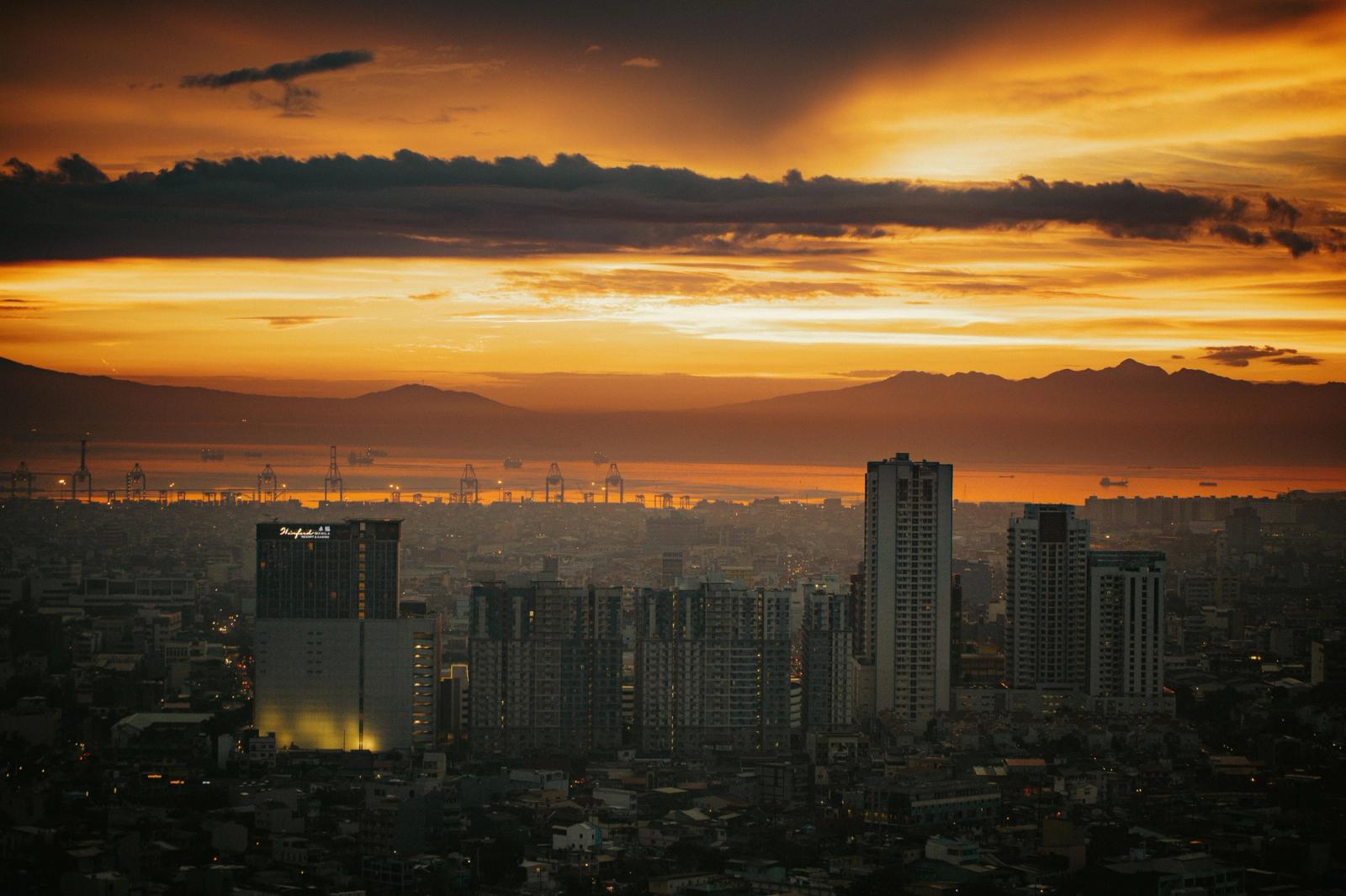 Breathtaking view of Manila's skyline at sunset, showcasing vibrant colors and cityscape