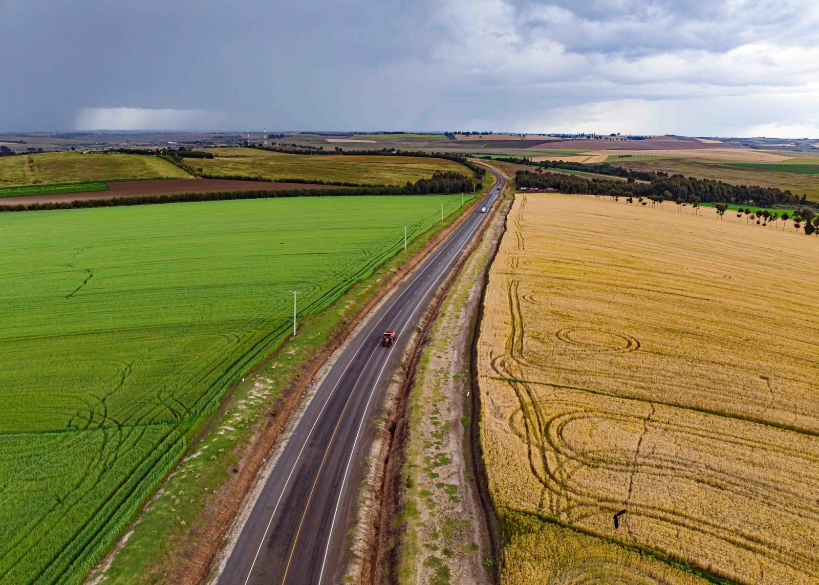 Scenic aerial view of a rural road between fields in Mau Narok, Kenya. Perfect for travel and nature themes