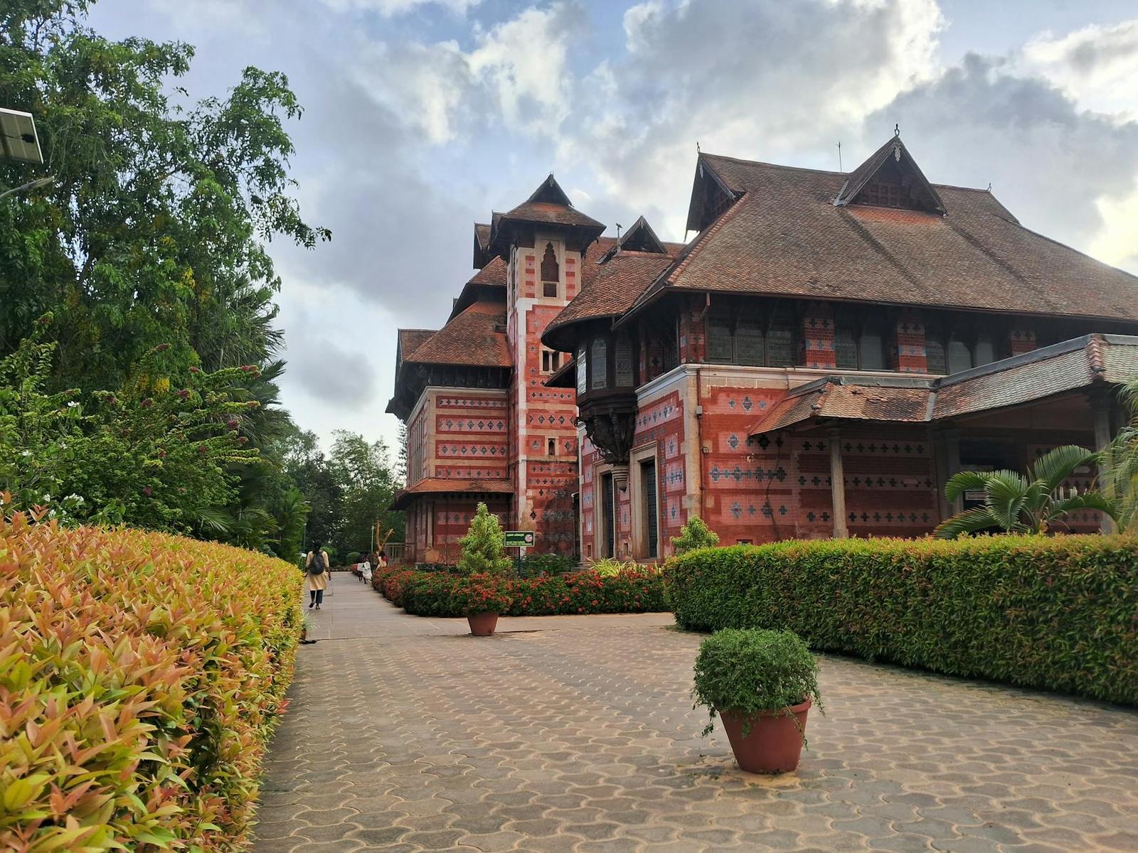 An ornate wooden palace with tiered red roofs and carved details