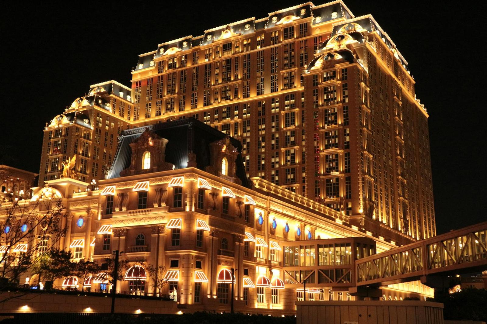 A brightly lit high-rise hotel and casino complex at night