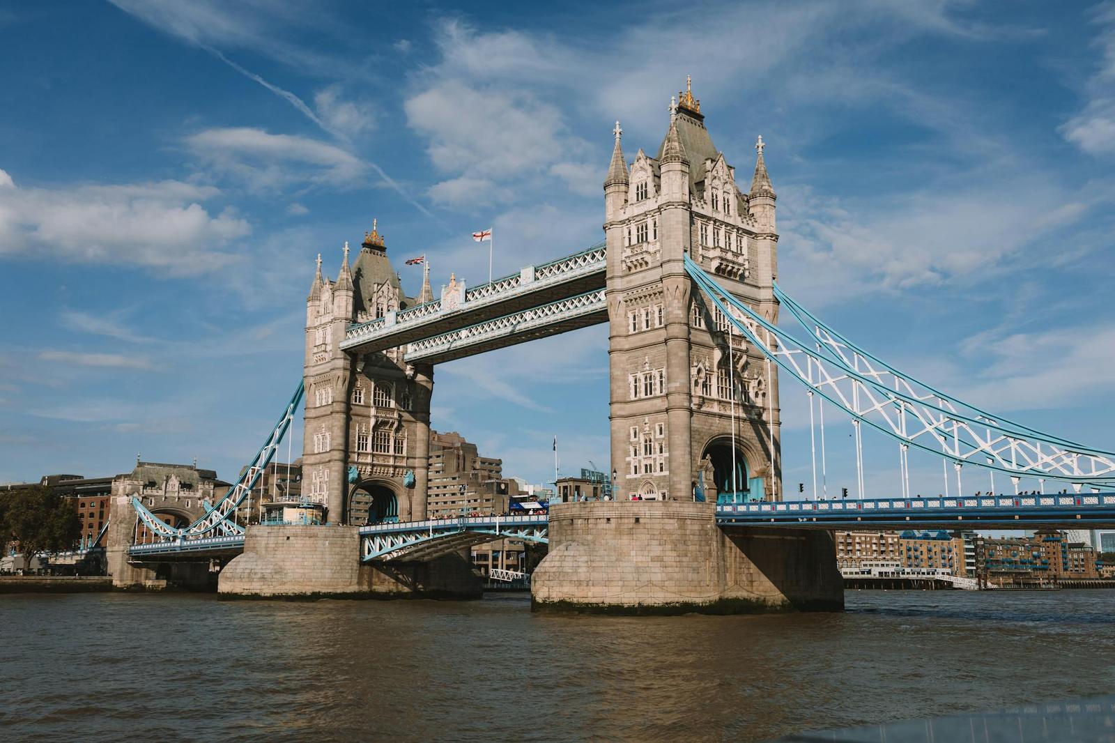 View of the iconic Tower Bridge spanning the River Thames in London, England on a sunny day