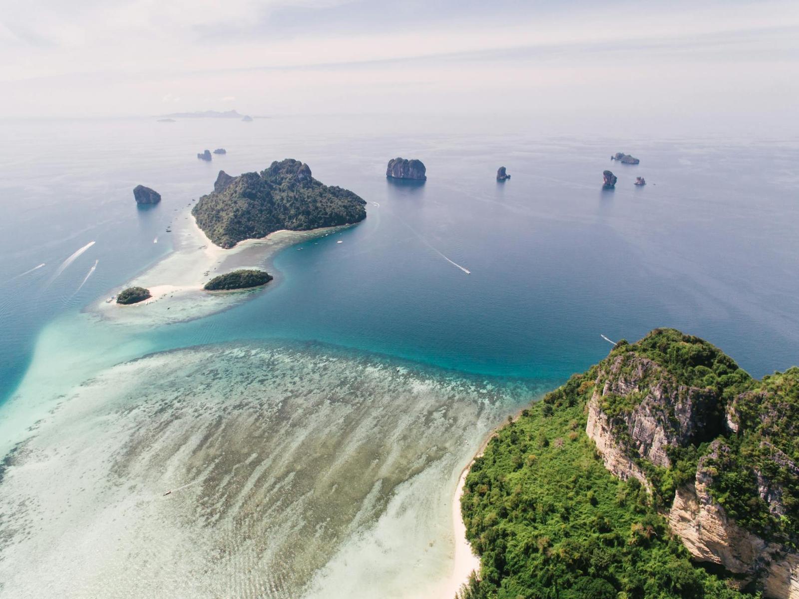 Aerial view of limestone islets scattered across a turquoise bay
