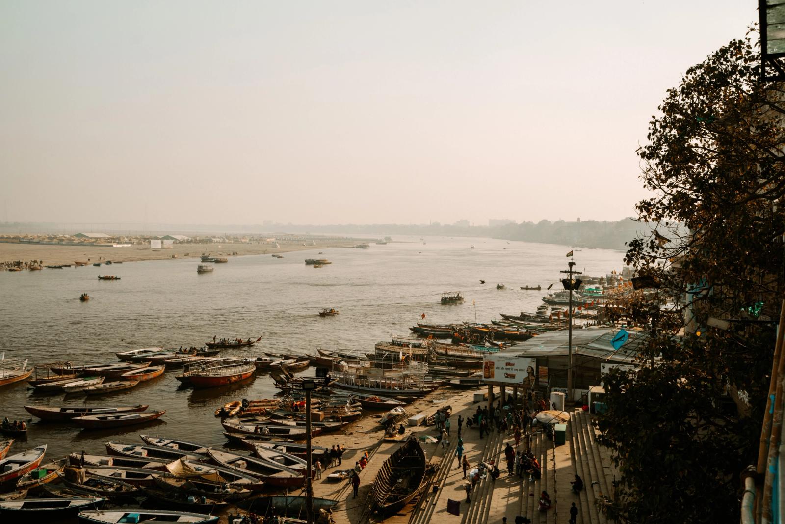 A busy harbor scene with boats on the Ganges River in Varanasi, India