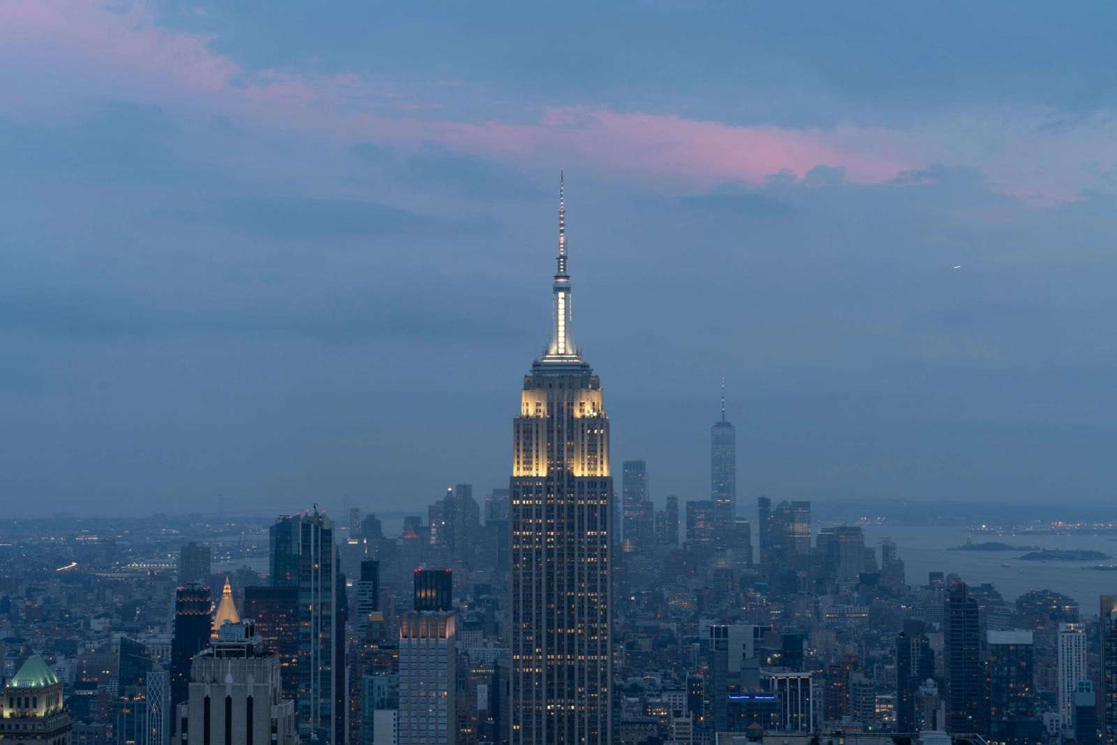 Iconic New York skyline featuring the Empire State Building at twilight with a vibrant sky