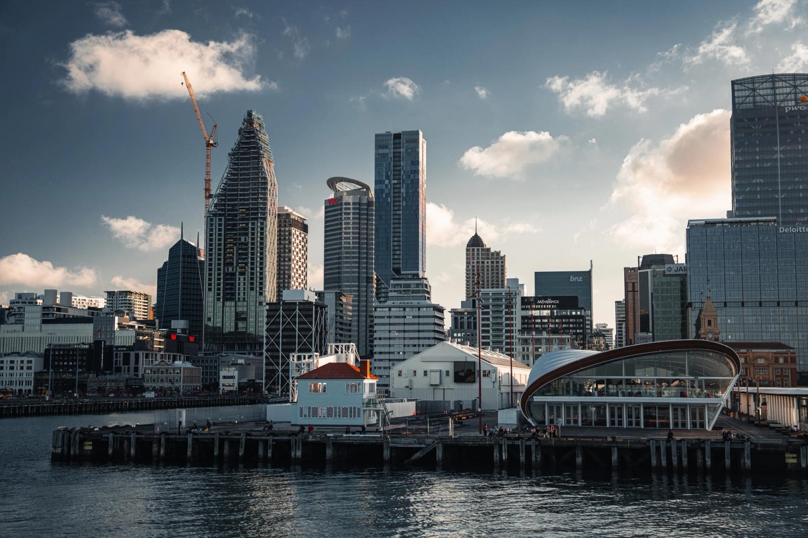 Explore the modern skyline of Auckland with its iconic waterfront view featuring skyscrapers and a tranquil harbor