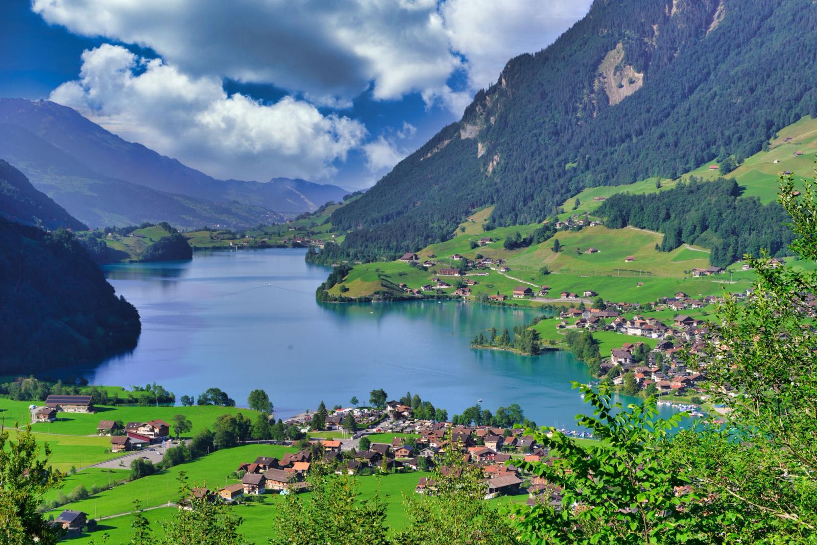 Picturesque towns by a lake with mountains in Switzerland during summer