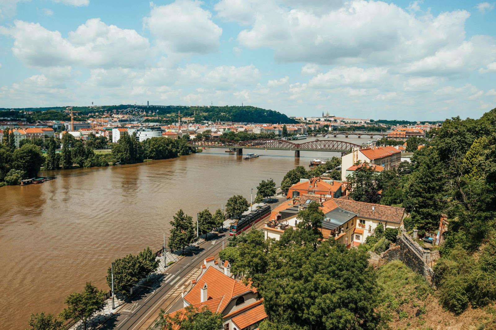 Aerial view of Prague's historical landscape featuring the Vltava River and iconic bridges