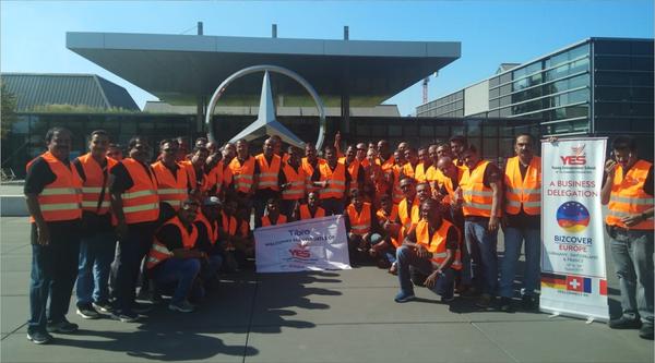 A group of people holding a large banner