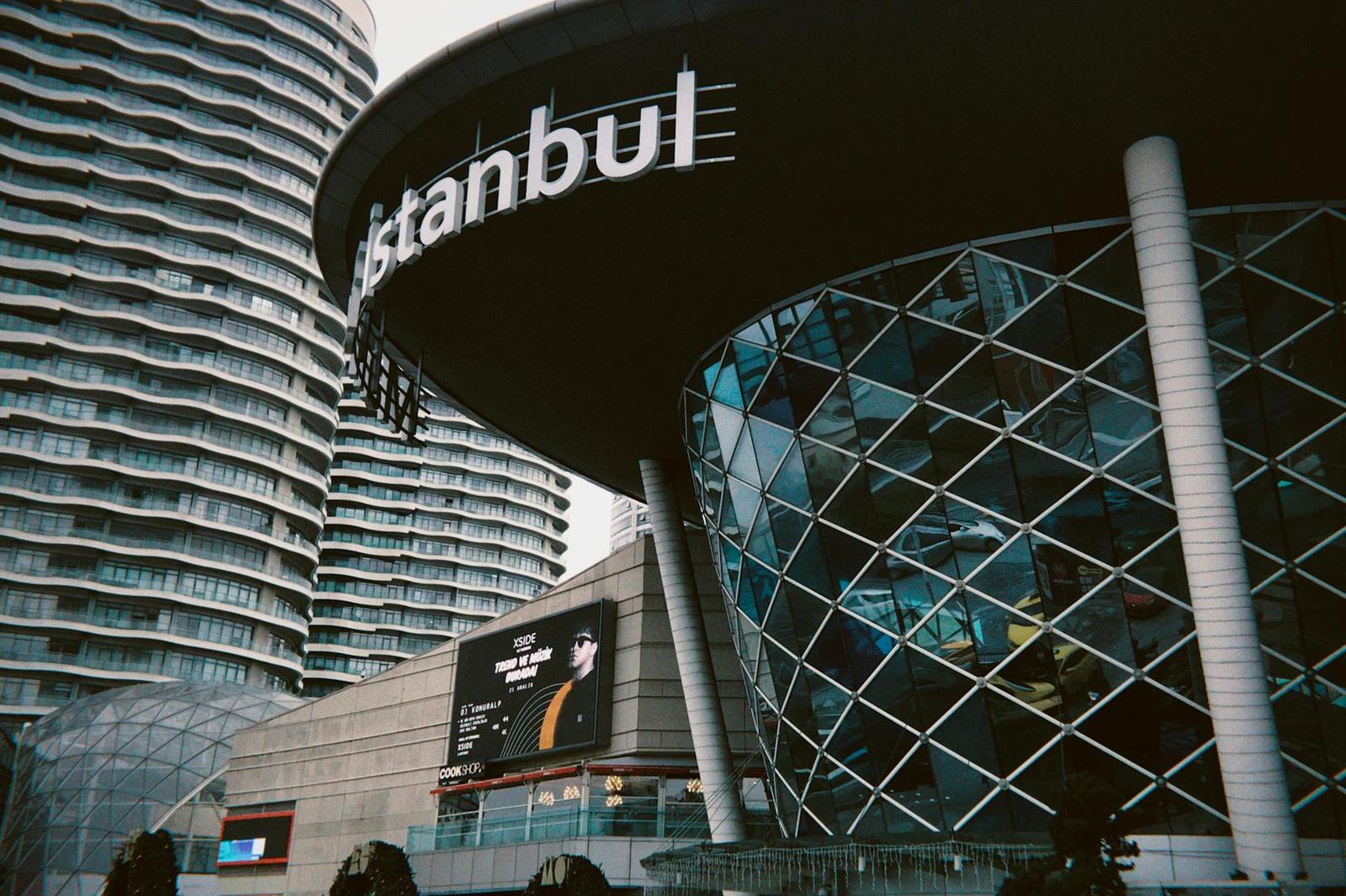 Modern glass mall entrance with an Istanbul sign overhead
