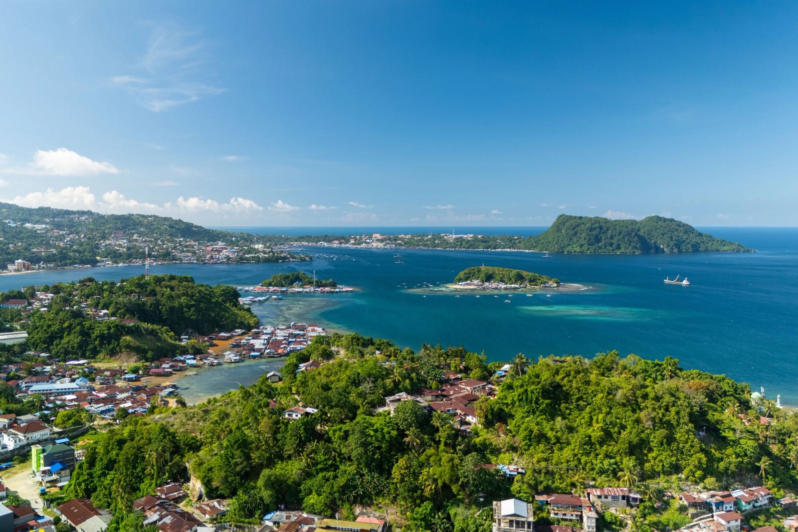 Explore the breathtaking coastal landscape of Jayapura, Papua, with vibrant tropical scenery and azure waters