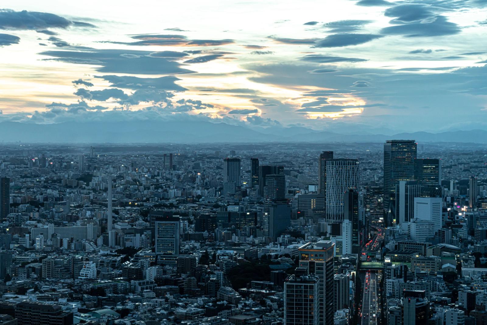 Aerial view of Minato City, Tokyo at dusk with dramatic cloud formations and city lights