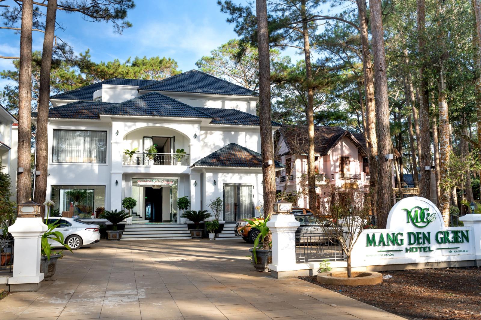 Beautiful entrance of Mang Den Green Hotel surrounded by serene forest. Ideal for luxury stays