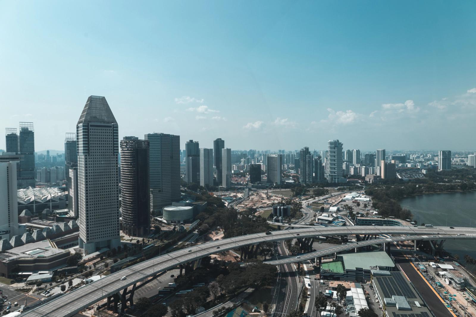 A breathtaking aerial view of Singapore's modern skyline featuring skyscrapers and highways