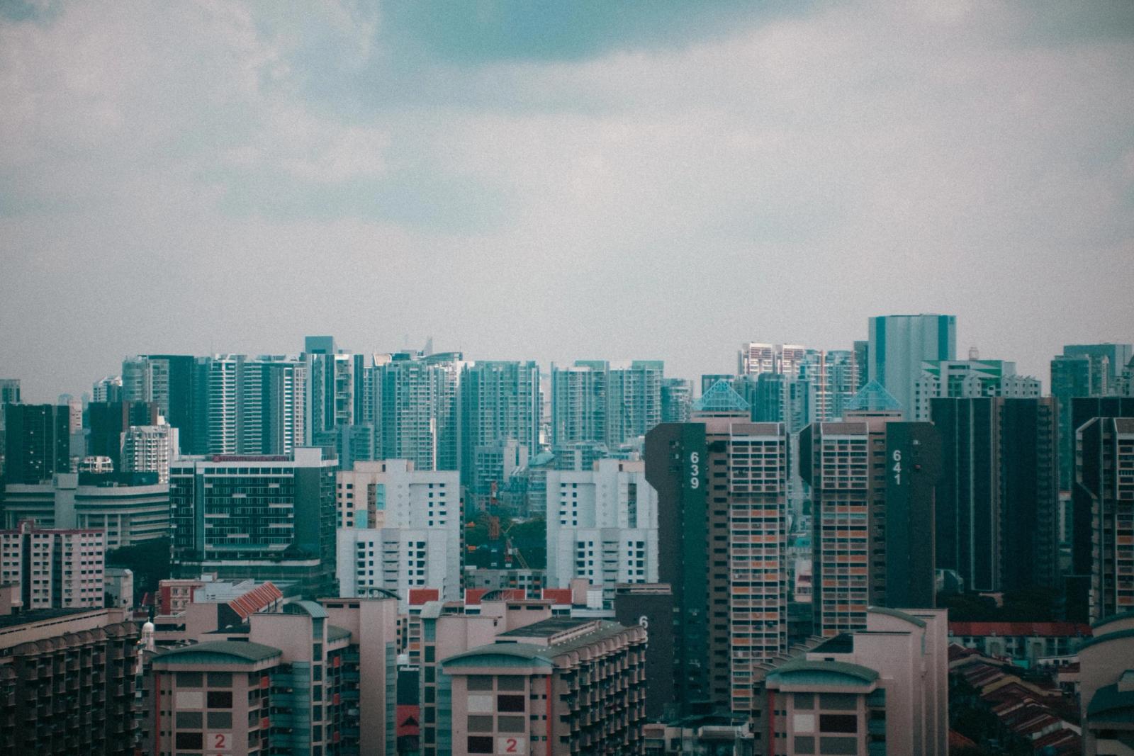 A stunning cityscape view of Singapore's high-rise buildings under a cloudy sky, showcasing urban architecture