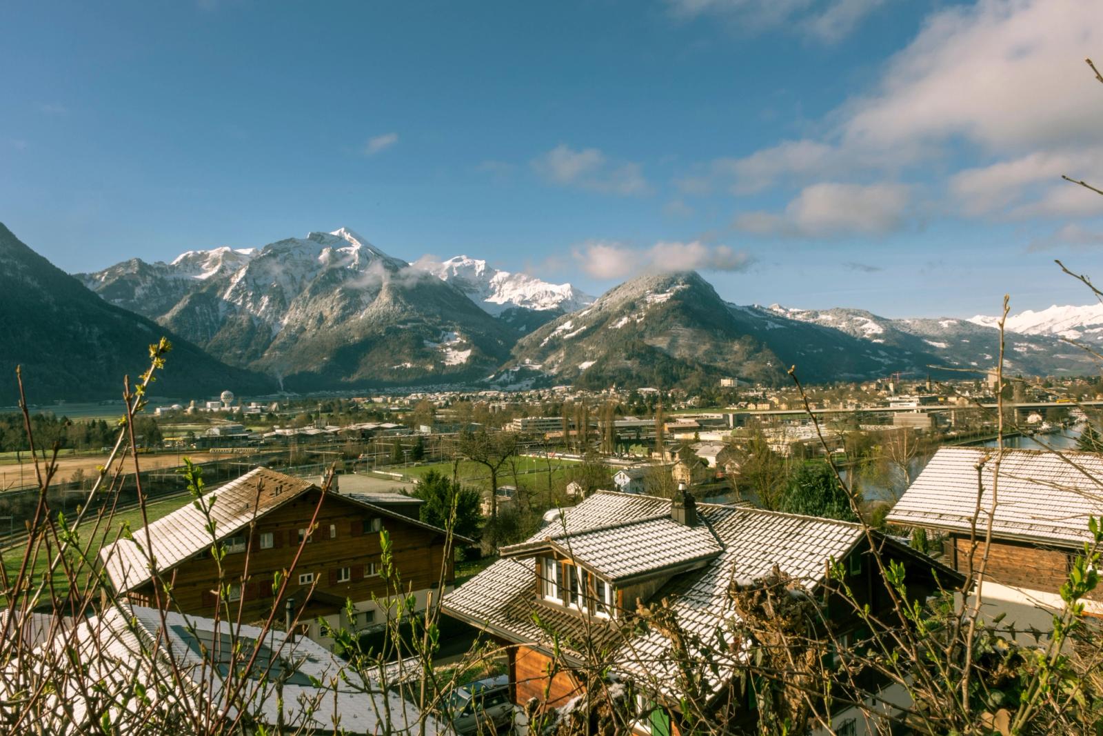 Picturesque winter landscape of Interlaken, showcasing snow-capped mountains and charming wooden houses