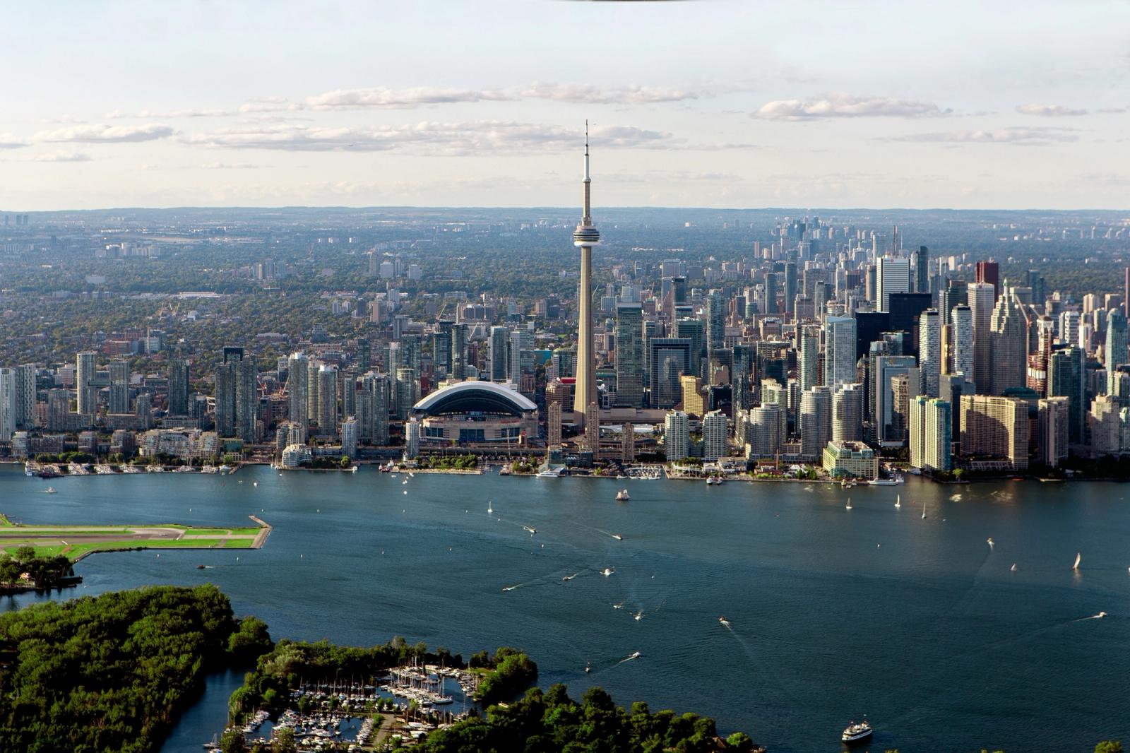 gray buildings near body of water in aerial photo Skyline of the city of Toronto taken from a plane