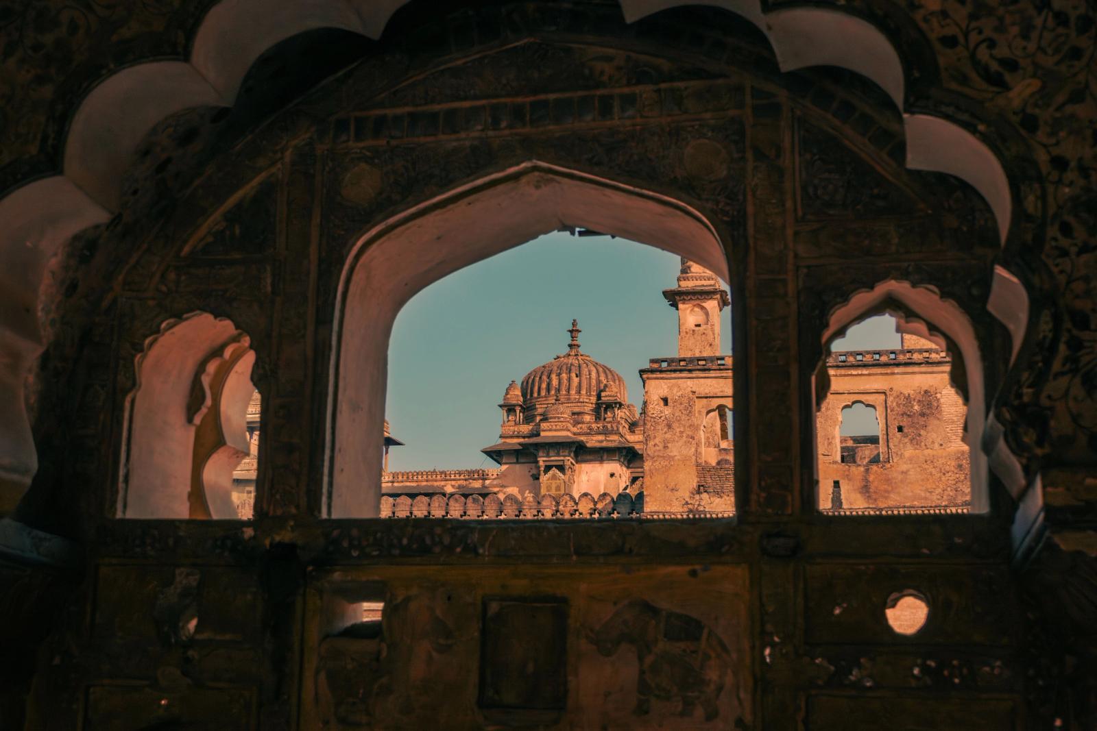 View of Orchha Fort in MP, India showcasing Mughal architecture through a decorative window