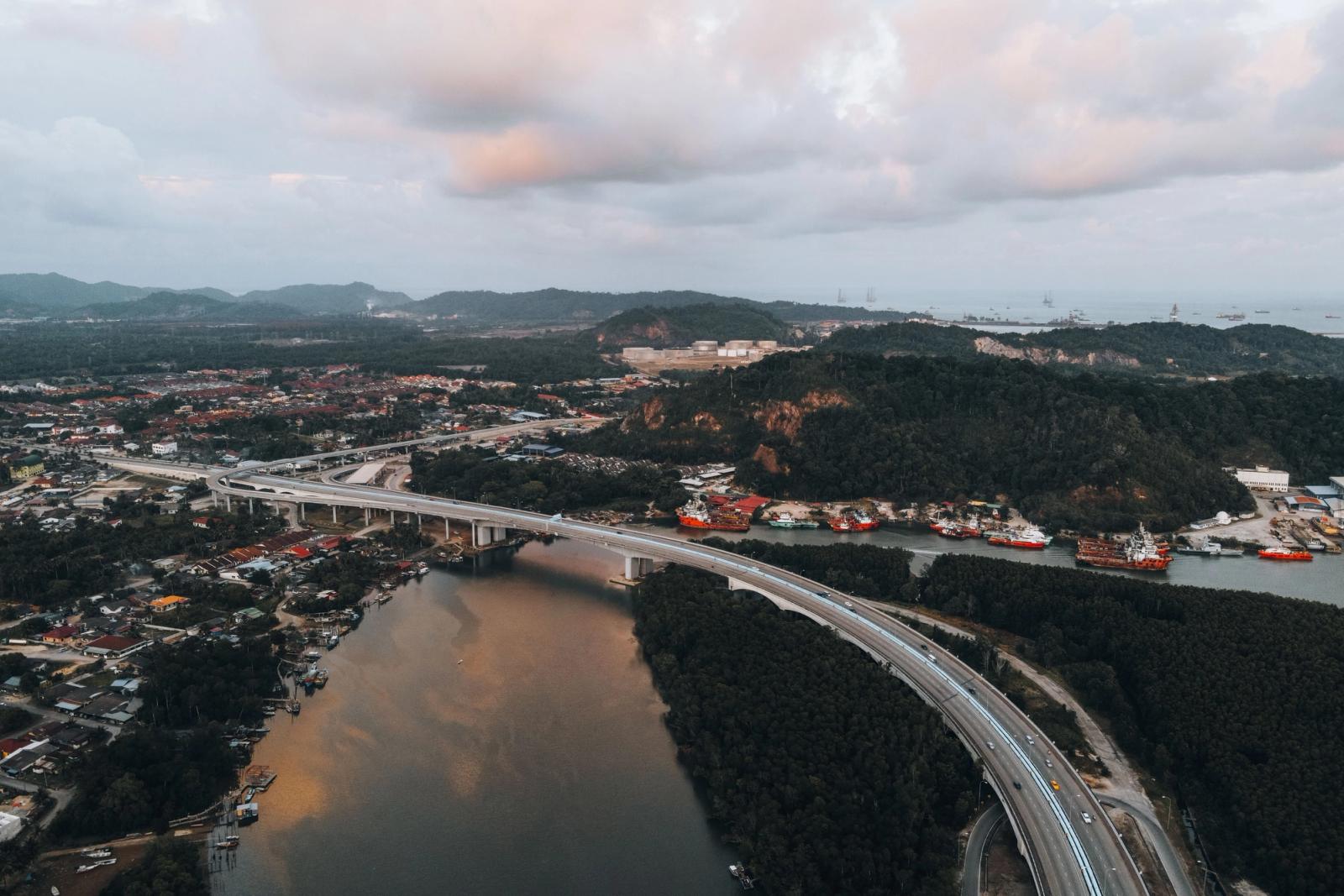 A breathtaking aerial view of the Chukai bridge amidst lush greenery and river scenery in Terengganu, Malaysia
