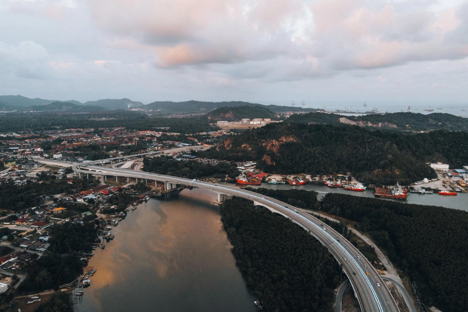 A breathtaking aerial view of the Chukai bridge amidst lush greenery and river scenery in Terengganu, Malaysia