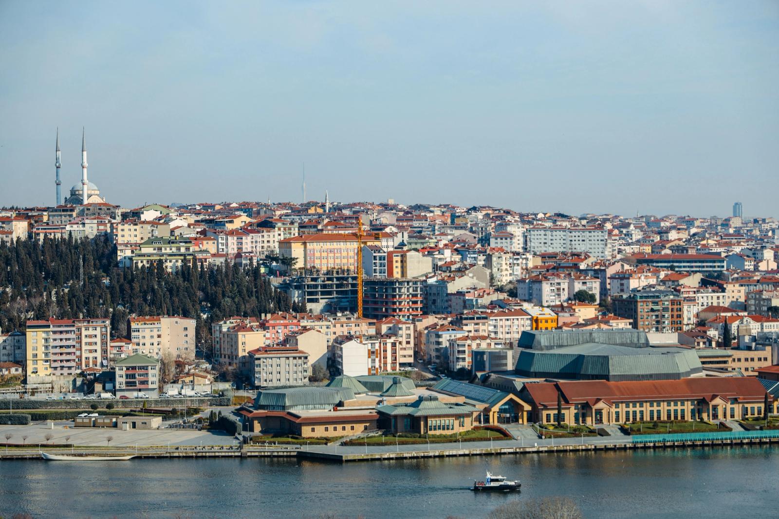 A scenic aerial view of Istanbul's skyline along the Bosphorus, capturing urban sprawl and a prominent mosque