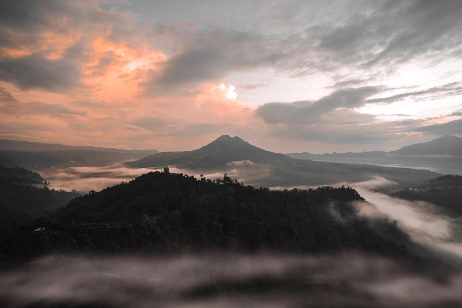 A breathtaking aerial shot of Bali's misty mountains during sunrise. Perfect for nature and travel enthusiasts