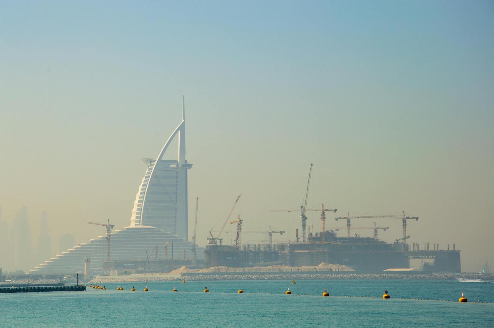 View of the Burj Al Arab and construction cranes in Dubai
