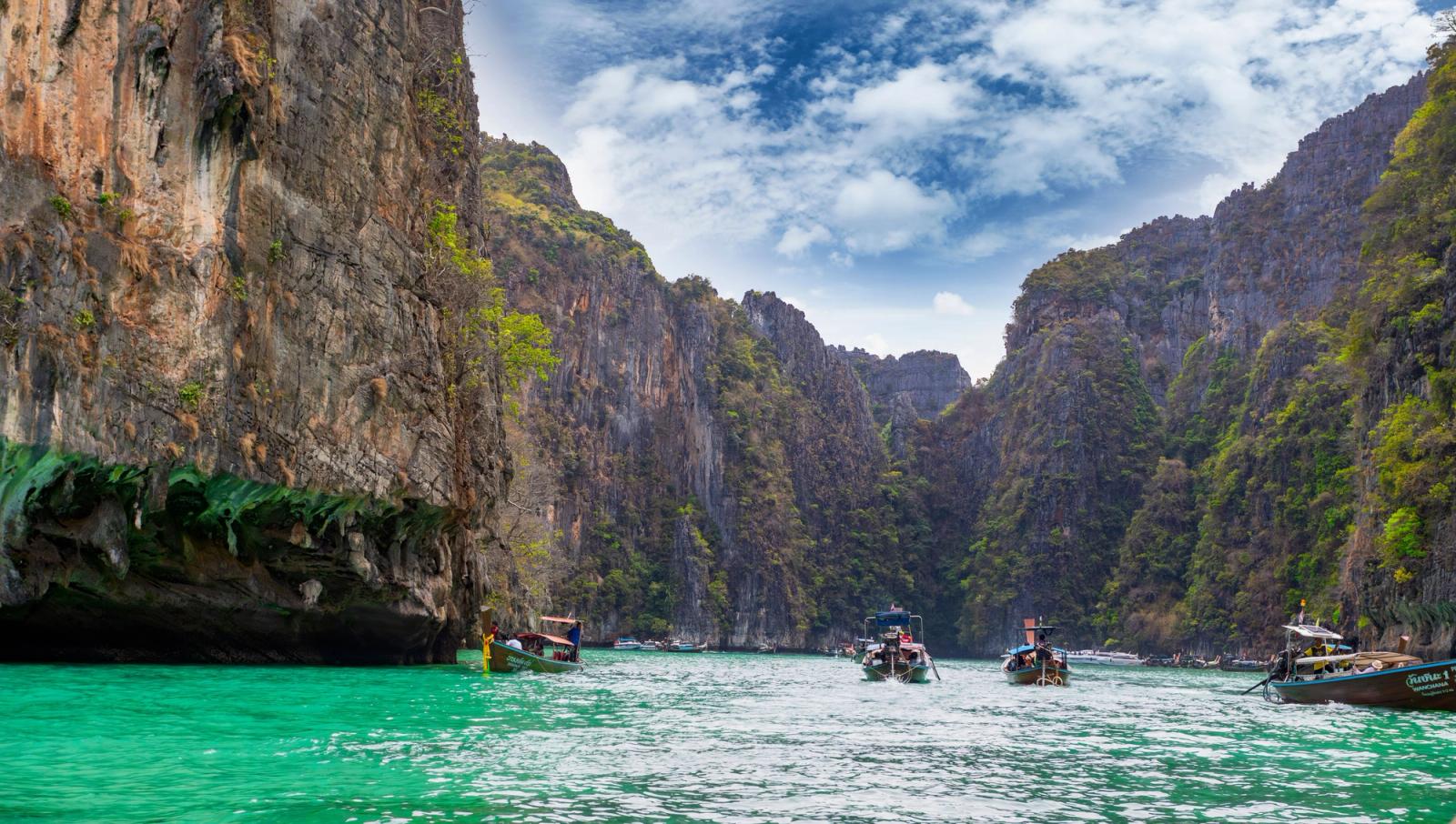 Explore the breathtaking cliffs and turquoise waters of Pi Leh Bay in Thailand, a popular travel destination