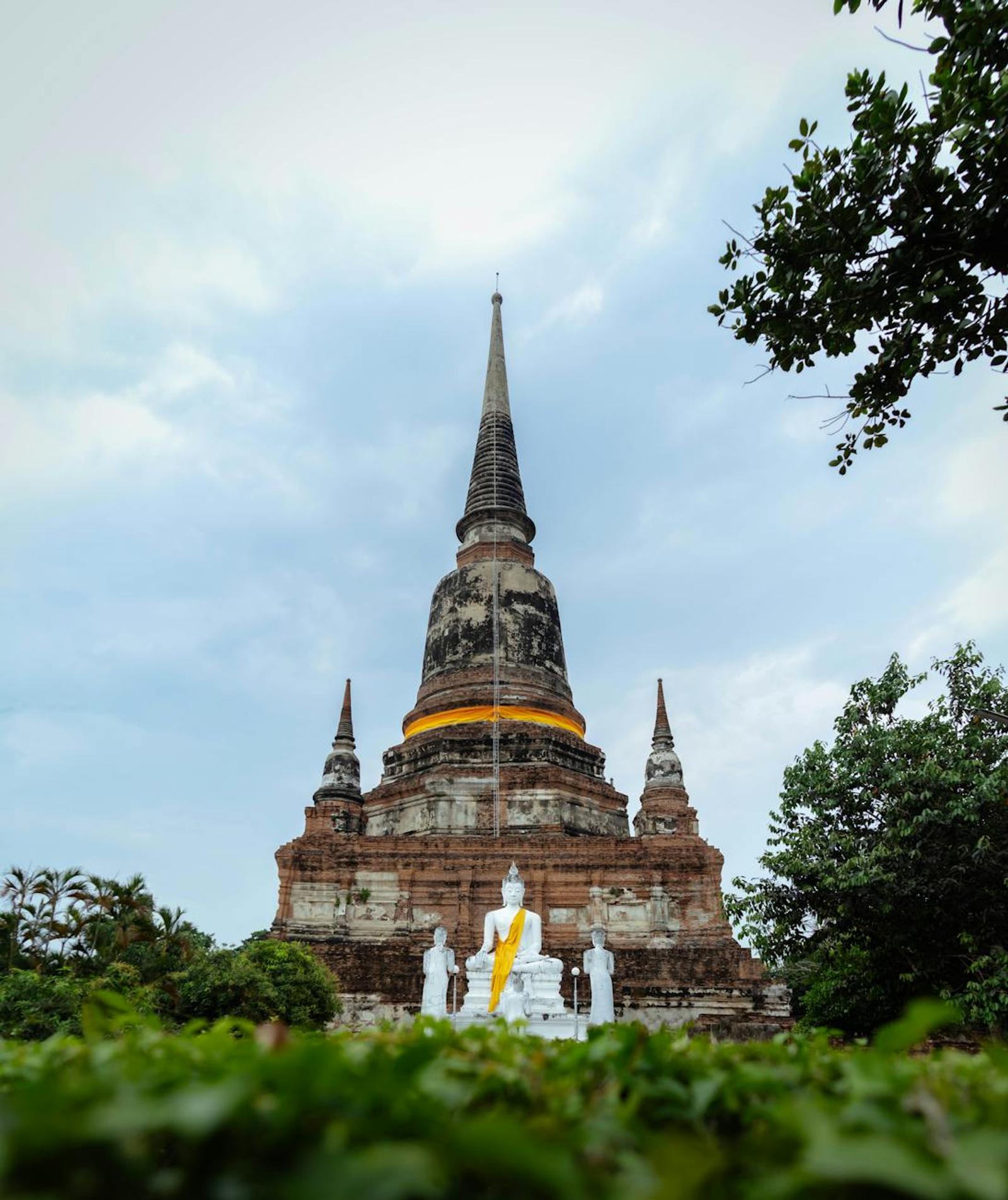 Serene view of Wat Yai Chai Mongkhon pagoda with Buddha statues in Ayutthaya, Thailand