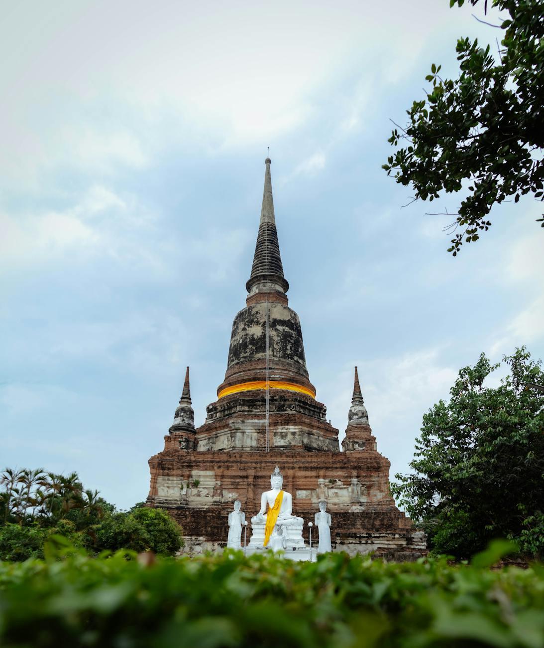Serene view of Wat Yai Chai Mongkhon pagoda with Buddha statues in Ayutthaya, Thailand