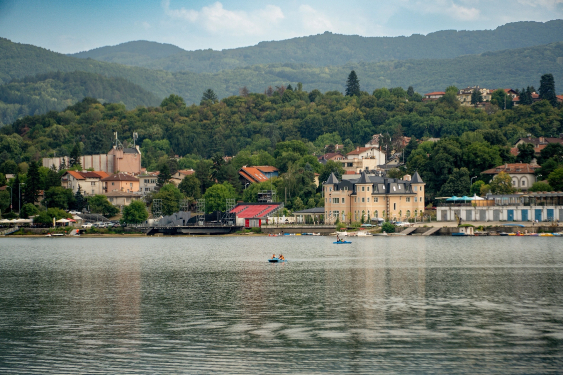Picturesque scene of Sofia's lakeside architecture and lush greenery from Iskar Lake, Bulgaria