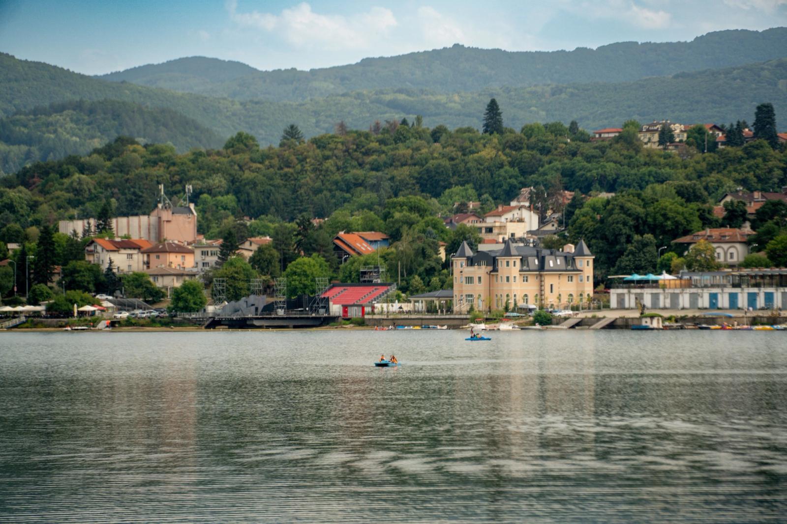 Picturesque scene of Sofia's lakeside architecture and lush greenery from Iskar Lake, Bulgaria