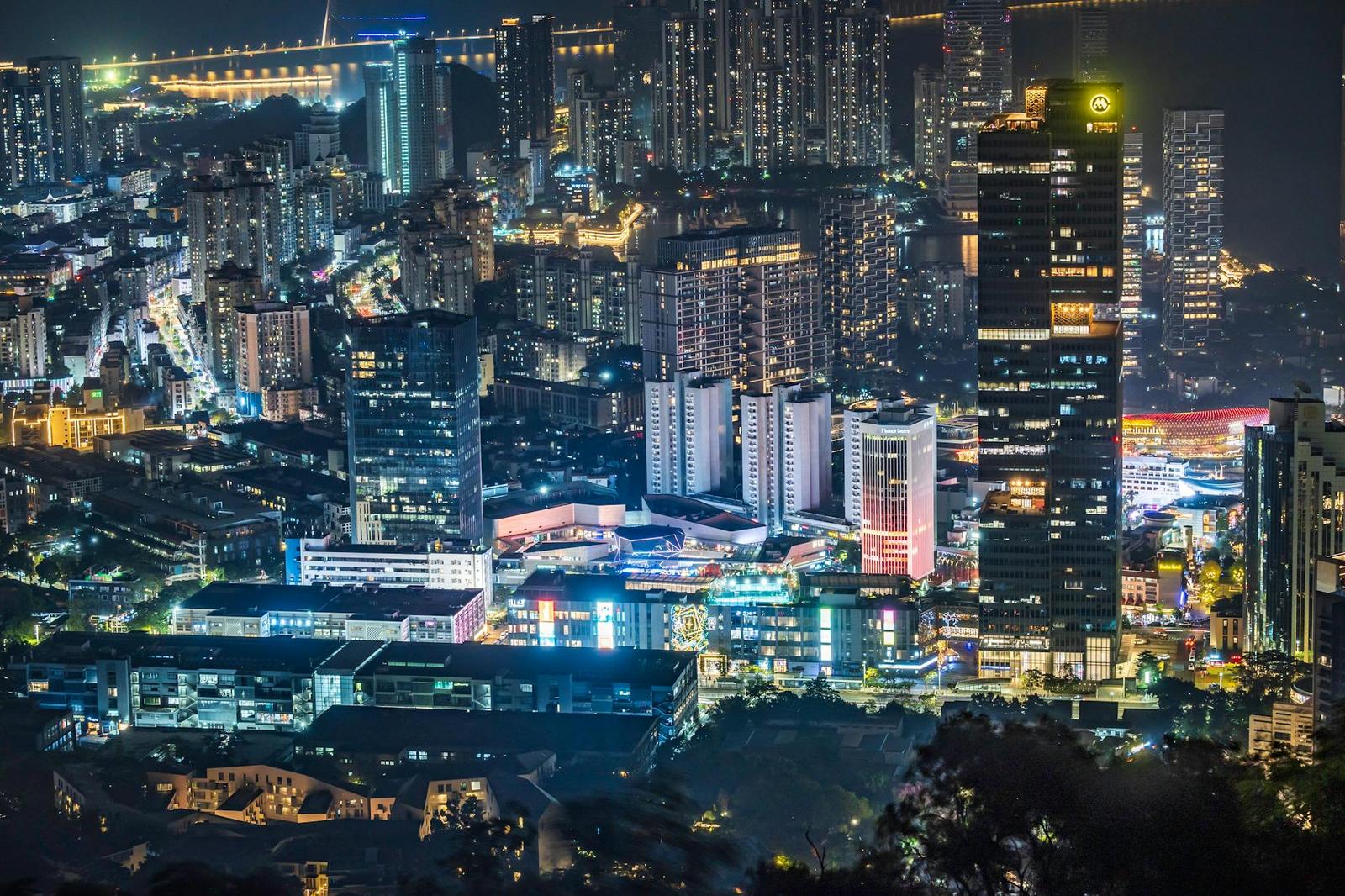 Dense city skyline lit up with skyscrapers at night