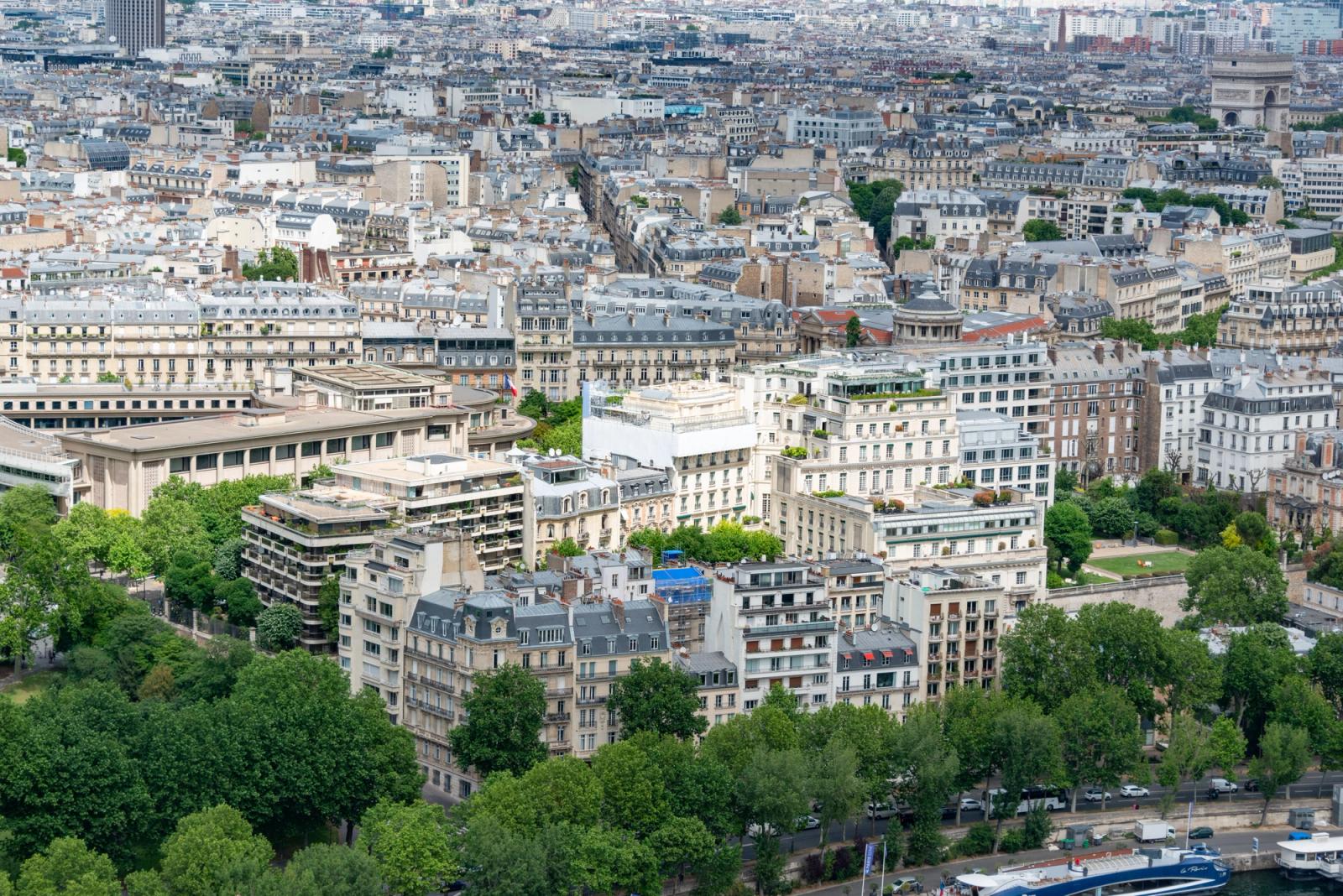 Panoramic aerial view of Paris featuring classic architecture and lush greenery, showcasing urban charm