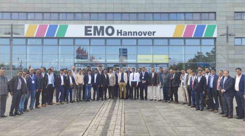 Group of people poses in front of an emo-themed Hanover building.